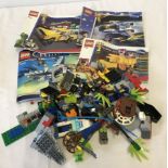 4 Lego instruction booklets together with a small quantity of mixed Lego pieces.