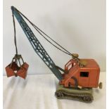 A vintage Gama tin plate and plastic battery operated grab crane.