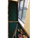 A Victorian bagatelle table with 2 cues and vintage balls.