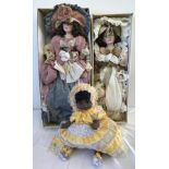 2 boxed porcelain dolls from the Knightsbridge collection together with a vintage black baby doll.