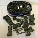 A tin of play worn military diecast vehicles.