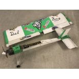 A large petrol engine radio controlled plane - Green & white coloured.