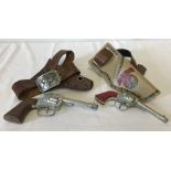 2 1950's toy guns with holsters and belts.