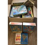 A box of children's vintage boxed jigsaw puzzles.