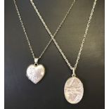 2 white metal lockets on chains.