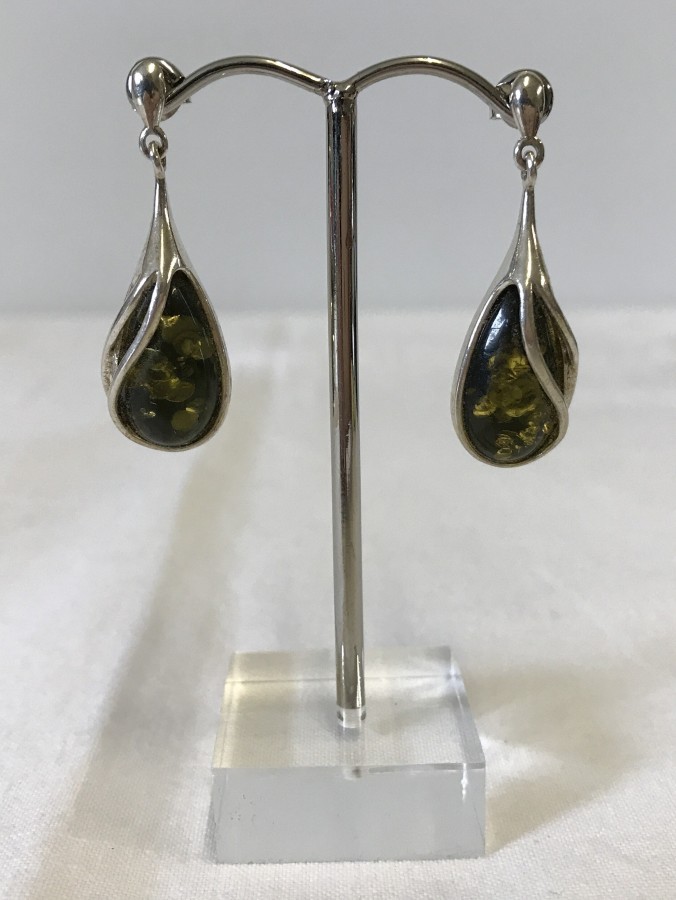 A boxed pair of green amber & silver drop earrings.