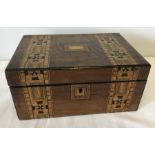 An wooden jewellery box inlaid with marquetry.