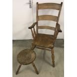 A vintage milking stool and ladder back chair.