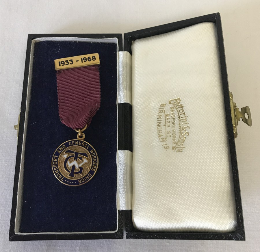 A boxed 9ct gold enamelled Fattorini & sons medal and pin on a maroon ribbon.