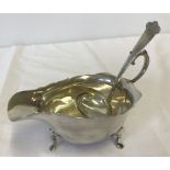 A silver sauce boat and ladle Hallmarked Birmingham 1915 and Birmingham 1916.