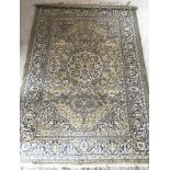 A Royal Tabriz wool rug in beige, green and blue colourway.