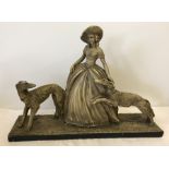 A vintage plaster figurine of a classical lady with two Irish Wolfhounds.