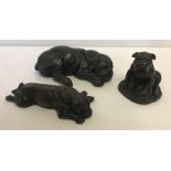 3 bronzed effect resin dog figures.