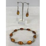 A matching amber & silver bracelet and amber & silver drop earrings.