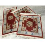 3 oriental dragon design rugs in red and cream colourways.