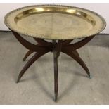 An oriental brass tray topped table.