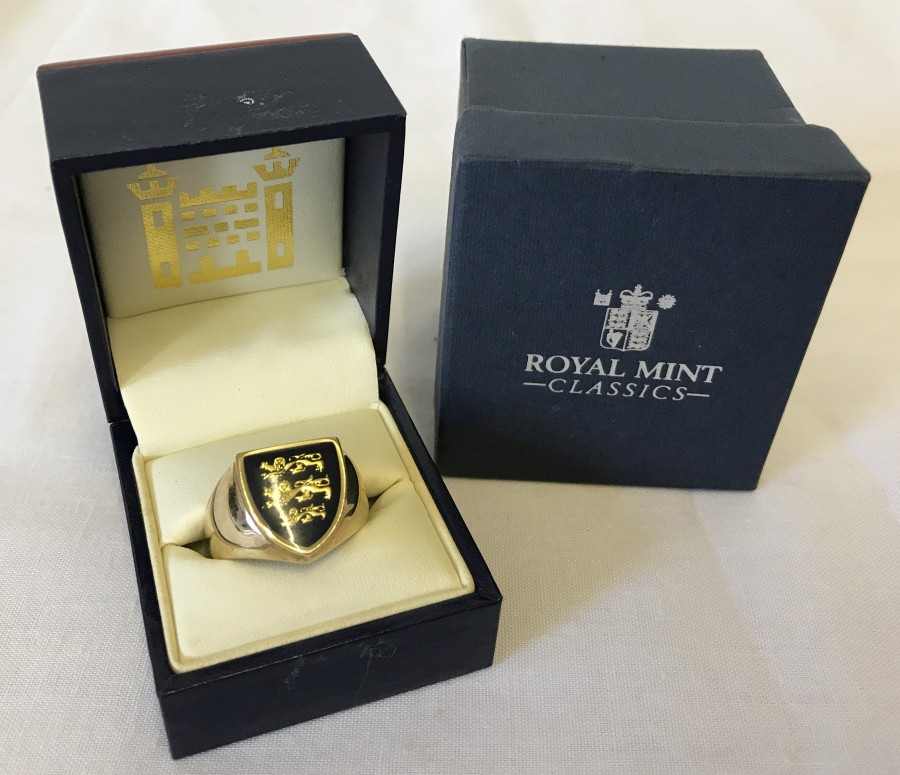 A boxed 9ct gold Royal Mint Three Lions of England gents signet ring.