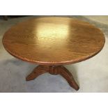 A small circular oak coffee table.