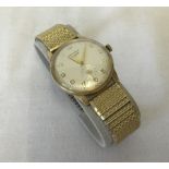 A Longines Gents 9ct gold wristwatch on a rolled gold strap.