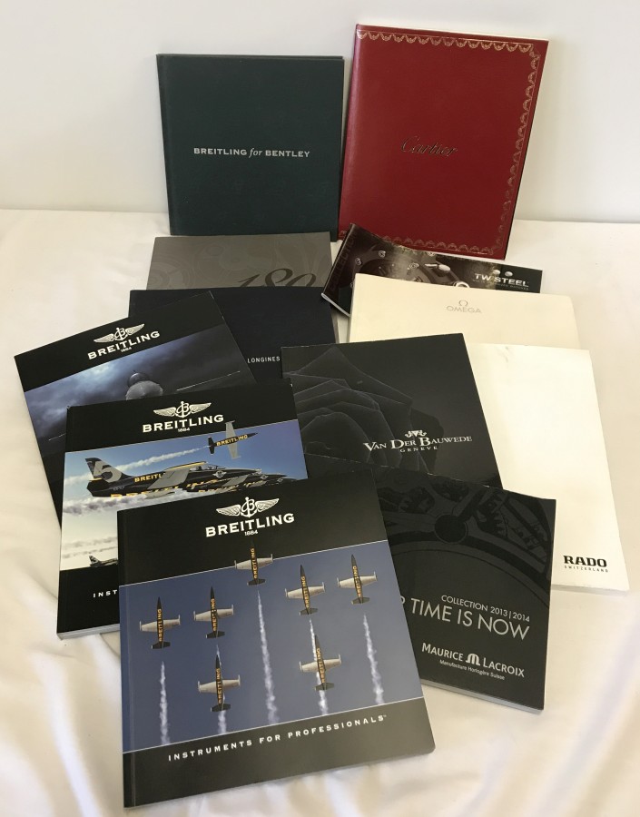 A quantity of watch catalogues to include Breitling, Cartier and Longines.