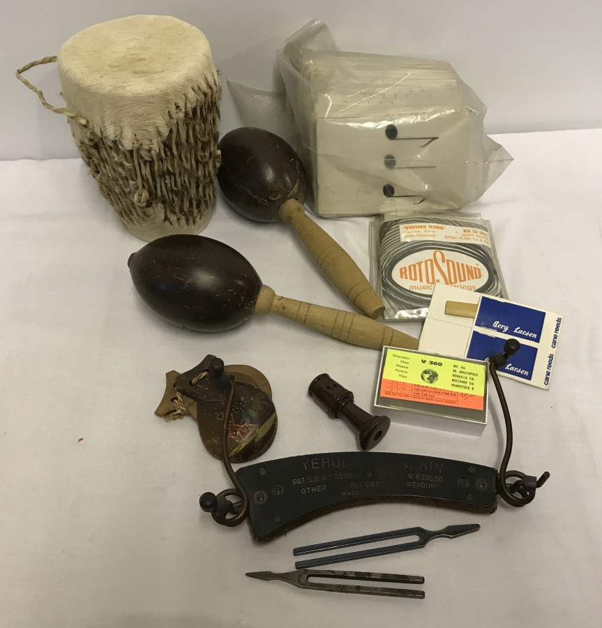 A box of assorted musical items to include maracas, Yehudi Menuhin chin rest and tuning forks.