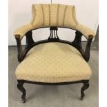 A Victorian library chair with lyre decoration and gold upholstery.