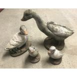 4 concrete garden duck ornaments.