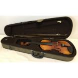 A cased violin with bow and rosin.