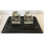 A wooden desk stand with 2 cut glass inkwells.
