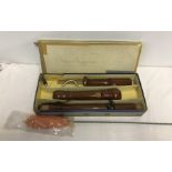 A vintage Günter Wunderlich bass recorder in original box together with a new cleaning mop.
