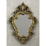 A small gilt plaster wall mirror.