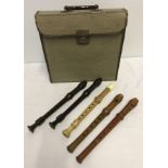 A quantity of vintage wooden and plastic descant recorders.