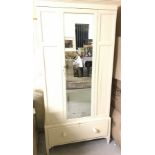 A vintage mirror doored single wardrobe, painted cream.