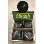 A boxed set of Almark Lawn bowls with Bowls measure.