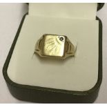 A hallmarked 9ct gold gents signet ring with small stone missing.