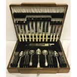 A lockable wooden cased Thomas Turner & Co, Sheffield plate canteen of cutlery with key.