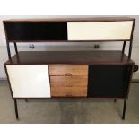 A c1960 sideboard unit on curved metal legs.