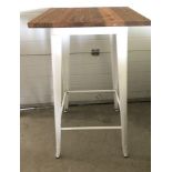 A modern wine bar style table with pressed steel frame and solid elm wooden top.