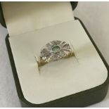 A 9ct gold Art Deco style ring set with diamonds and central oval green stone.