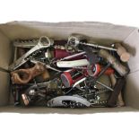 A box of assorted vintage corkscrews and bottle openers.