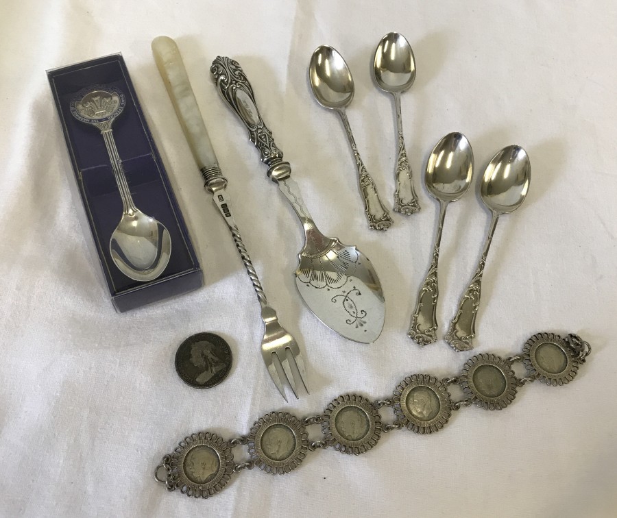 A collection of assorted silver items.