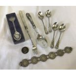A collection of assorted silver items.