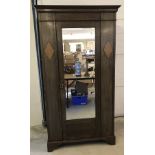 A circa 1930's dark oak single wardrobe with mirrored door and diamond motif to each side.