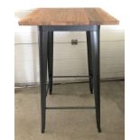 A modern bar style table with pressed steel frame and solid elm wooden top.