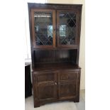 A dark oak Larkswood Ltd, Old Charm style dresser / display unit with internal lighting.