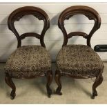 2 decorative Victorian balloon back chairs with front cabriole legs and ceramic castors.