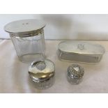 4 silver topped vanity jars.