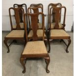 A set of 6 matching high back dining chairs with one other.