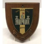 Painted Inniskillings badge on wooden shield 18cm x 15cm.