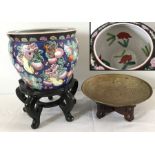 A oriental ceramic planter with interior fish decoration with wooden stand.
